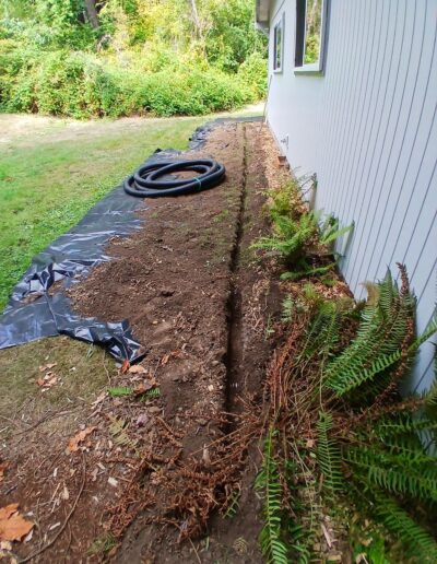 Installation of french drain in exterior areas by Foundations First Northwest